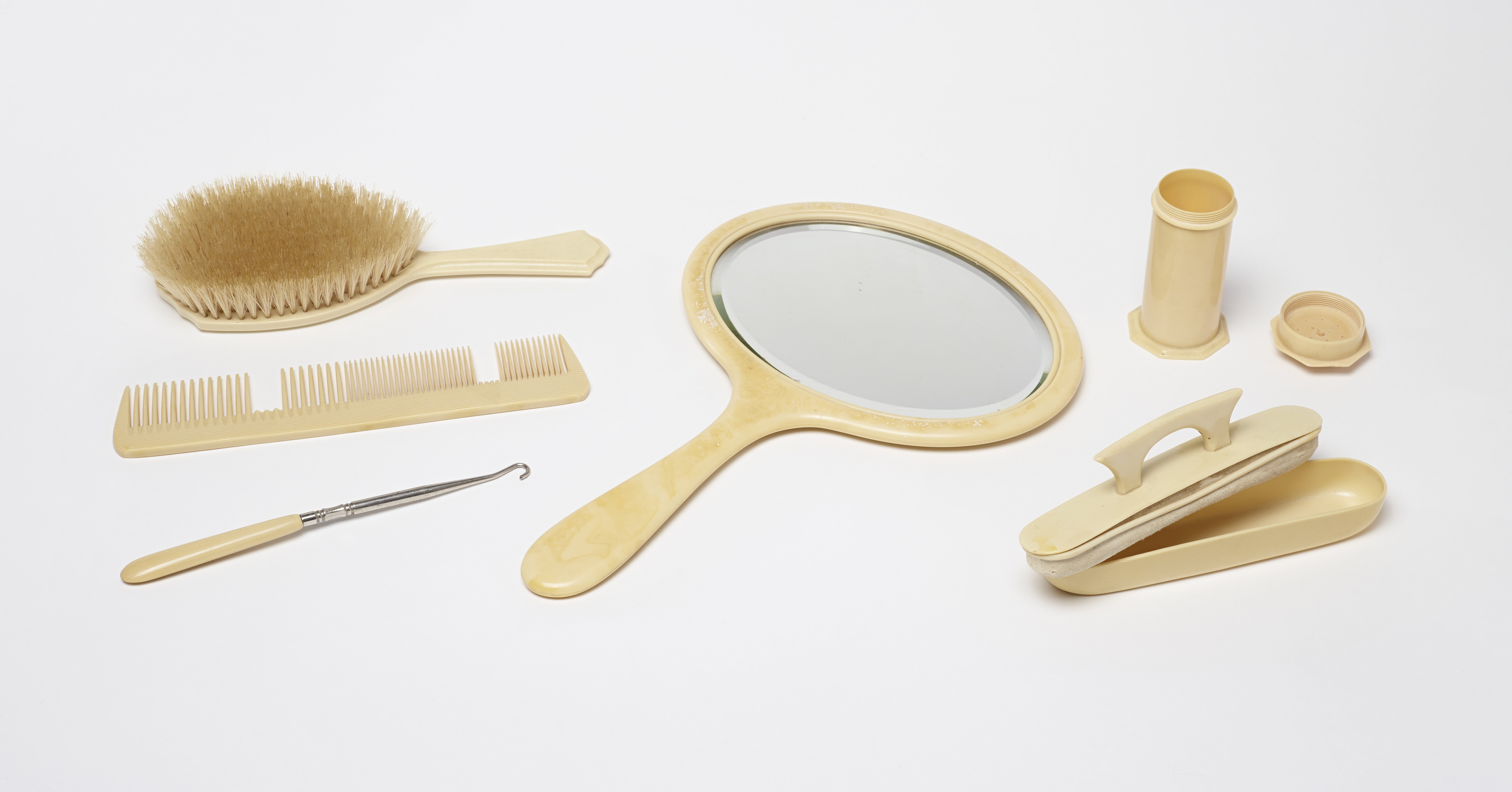 Pyralin mirror, hairbrush, comb, nail buffer, button hook, and trinket box  - Science History Institute Digital Collections